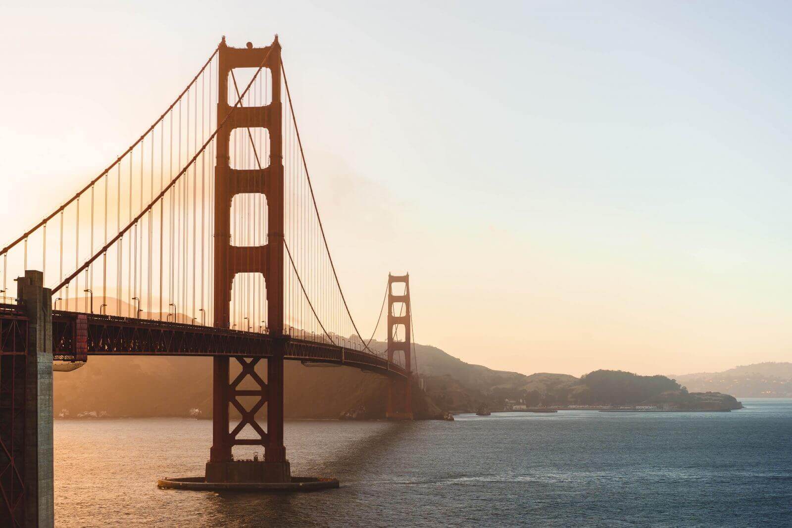 Golden Gate Bridge at sunset, San Francisco landmark, iconic suspension bridge over bay, scenic view.
