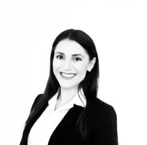 Professional woman in business attire, smiling confidently, isolated on white background. Ideal for corporate profile or LinkedIn.