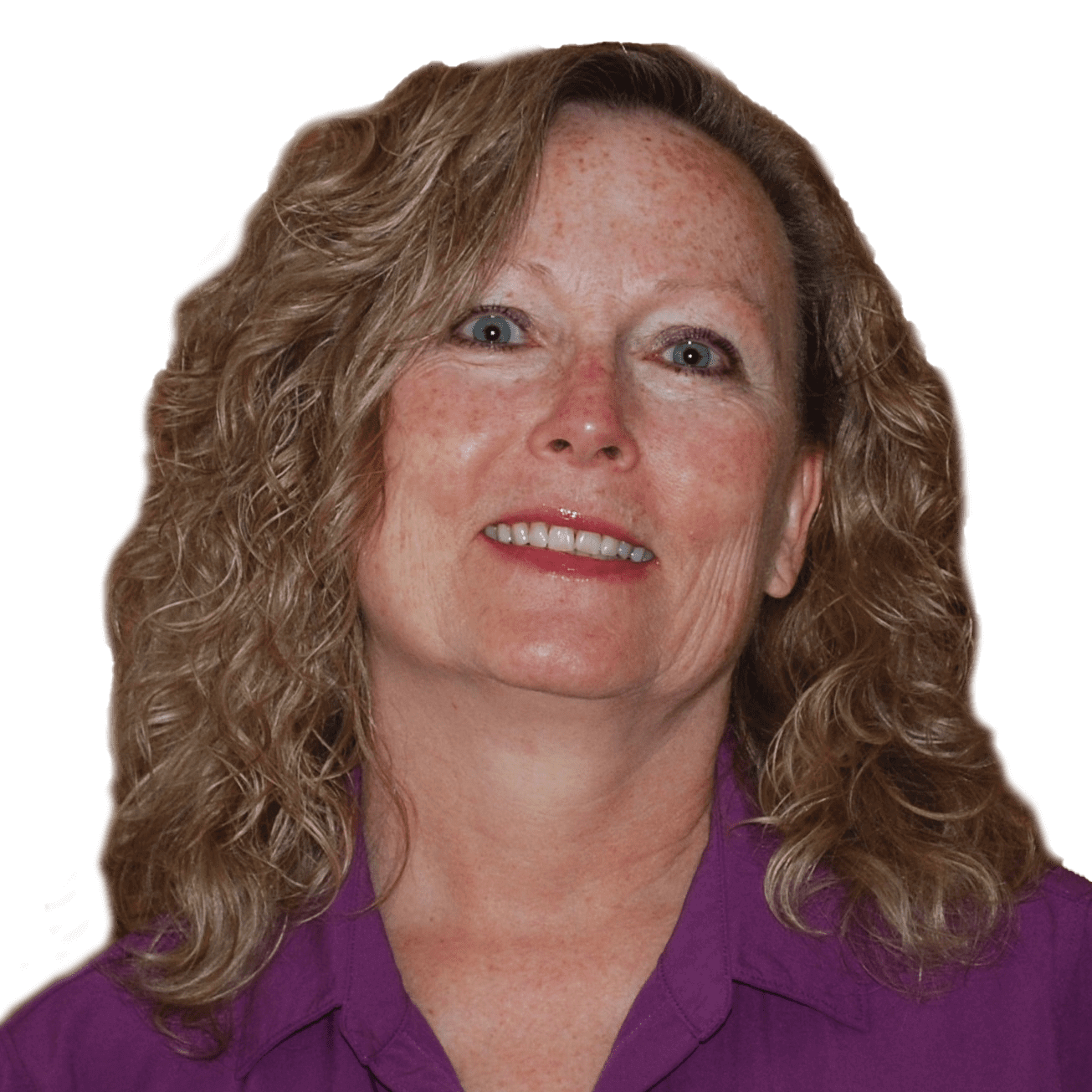 Curly-haired woman smiling in a purple shirt against a plain background.