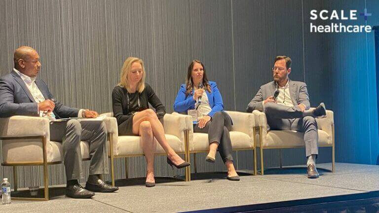 Panel discussion at MWE Conference 2023, featuring four professionals on stage, Scale Healthcare branding visible.
