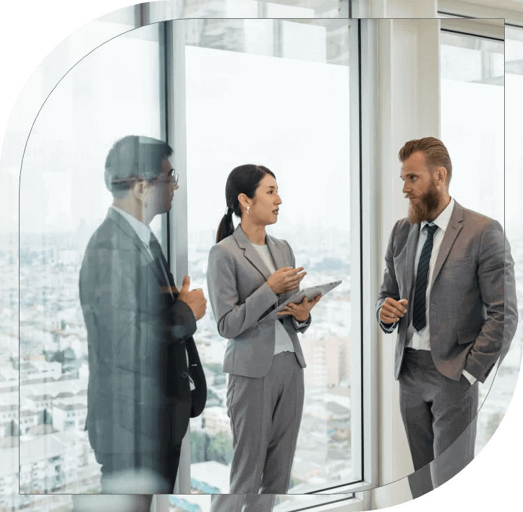 Business professionals in discussion, modern office, city view, teamwork, collaboration, corporate meeting, formal attire.